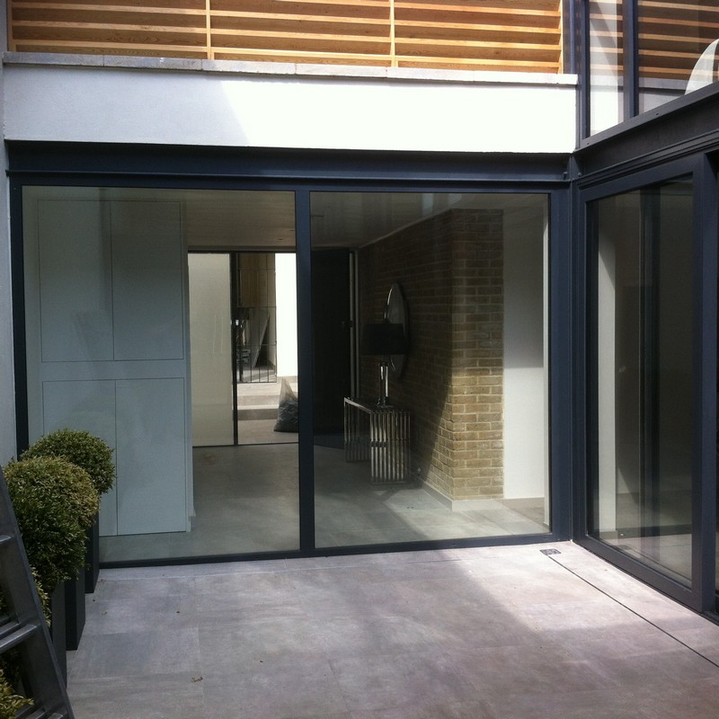 Floor-to-ceiling sliding doors opening to courtyard in Surbiton