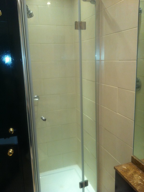 Frameless glass shower enclosure with chrome fittings in Surbiton