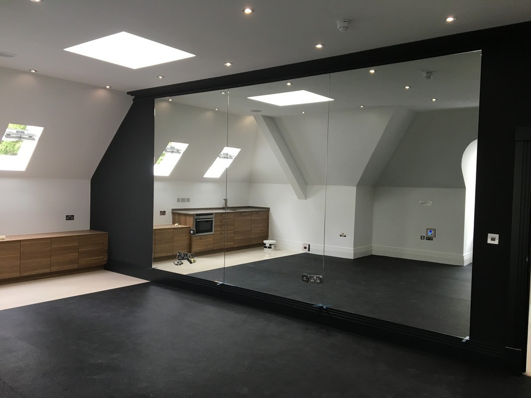 Frameless glass wall dividing loft conversion in Surbiton