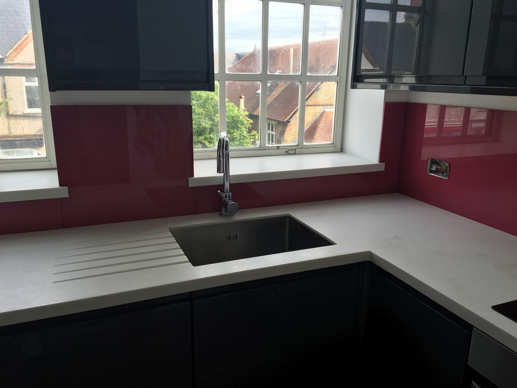 Deep plum coloured glass splashback in modern Surbiton kitchen